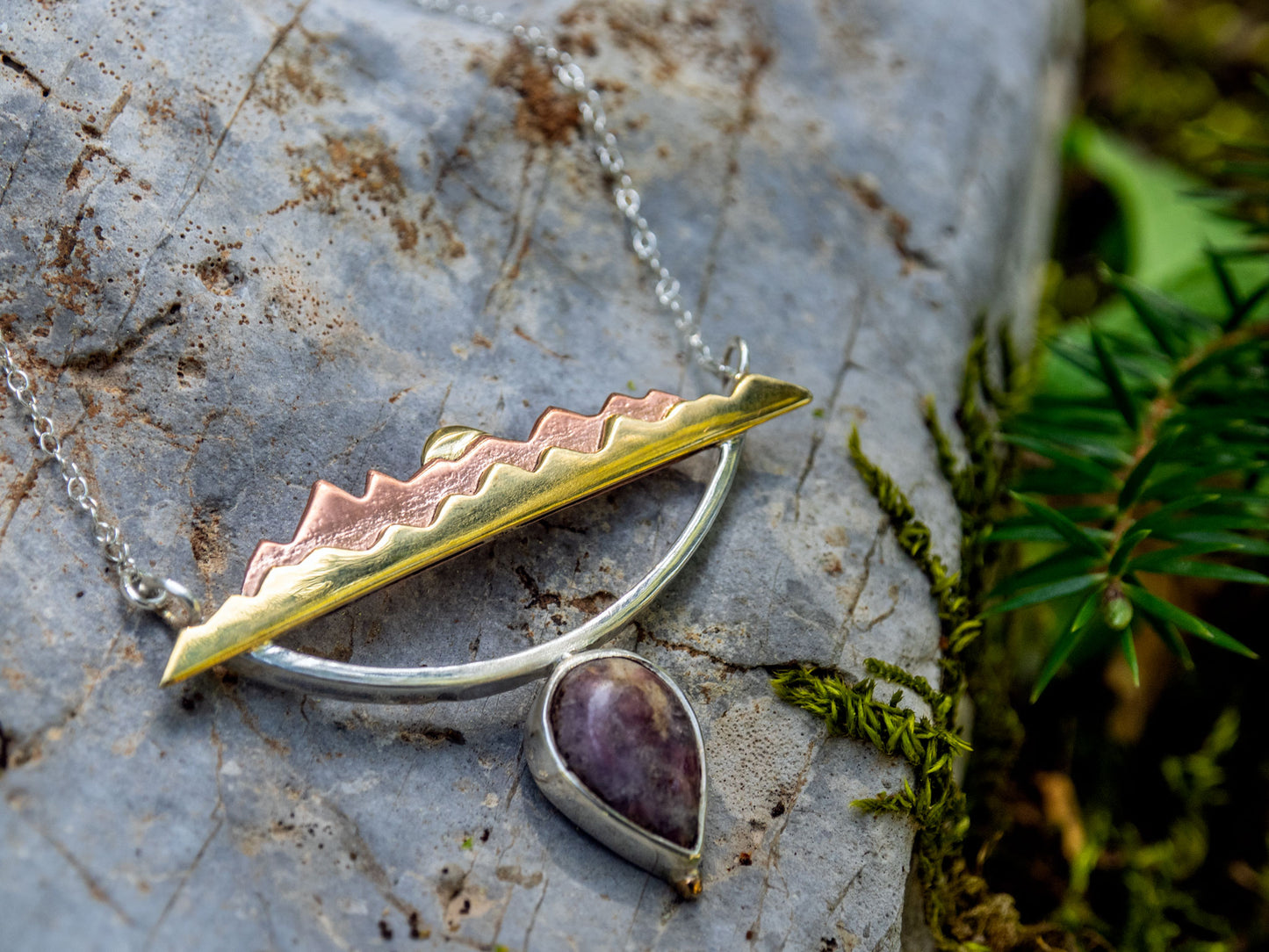 Mixed metal necklace with a Tourmaline stone and a mountain scene