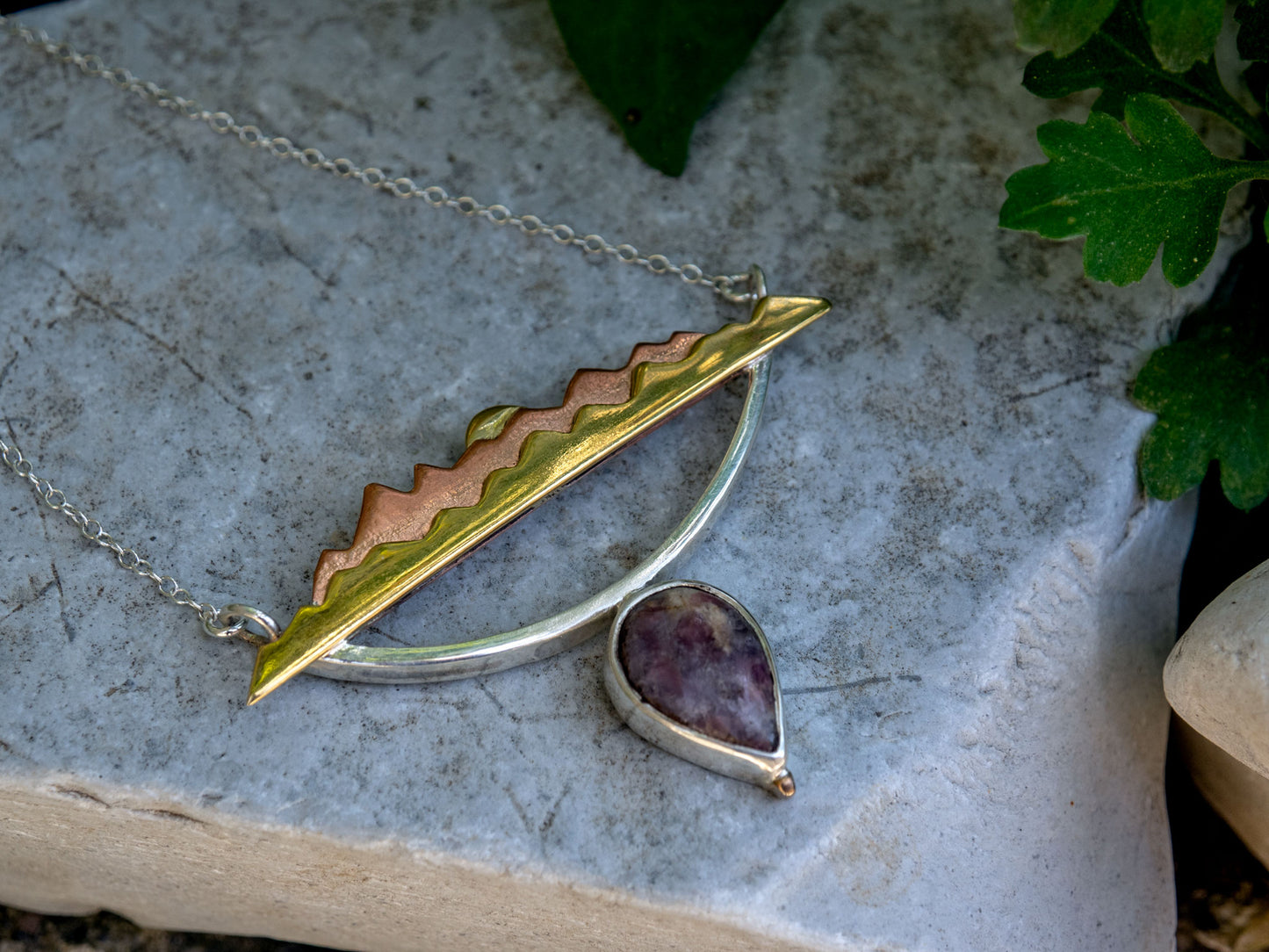 Mixed metal necklace with a Tourmaline stone and a mountain scene